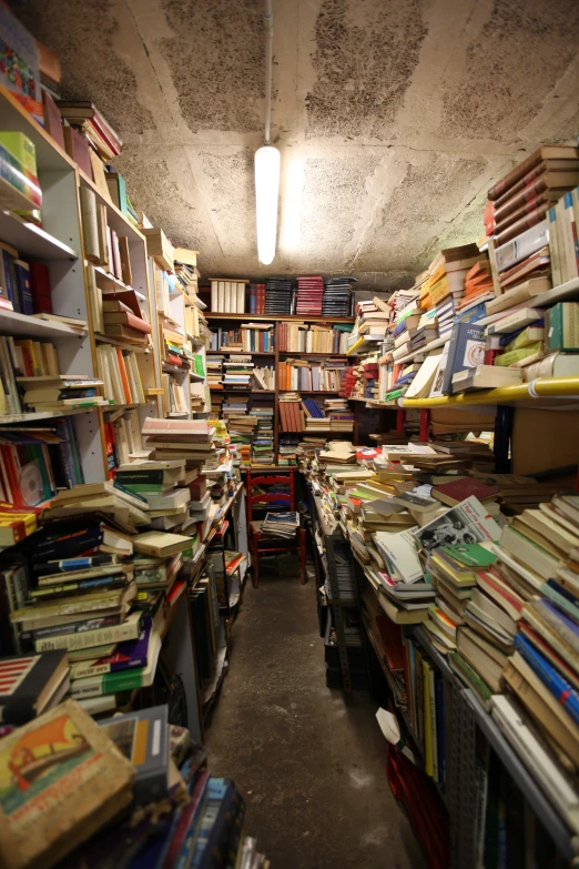 books and magazines are stacked in the end of the room