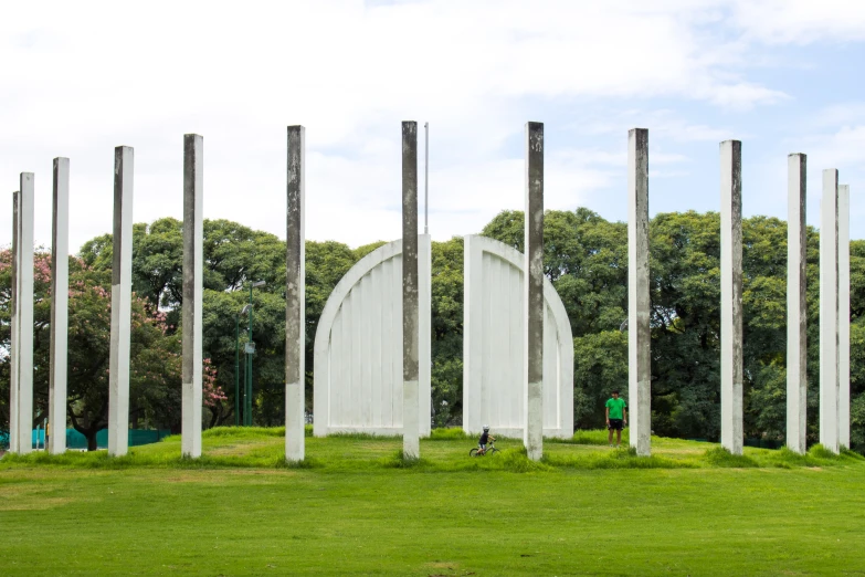 a group of poles sitting in the middle of a field