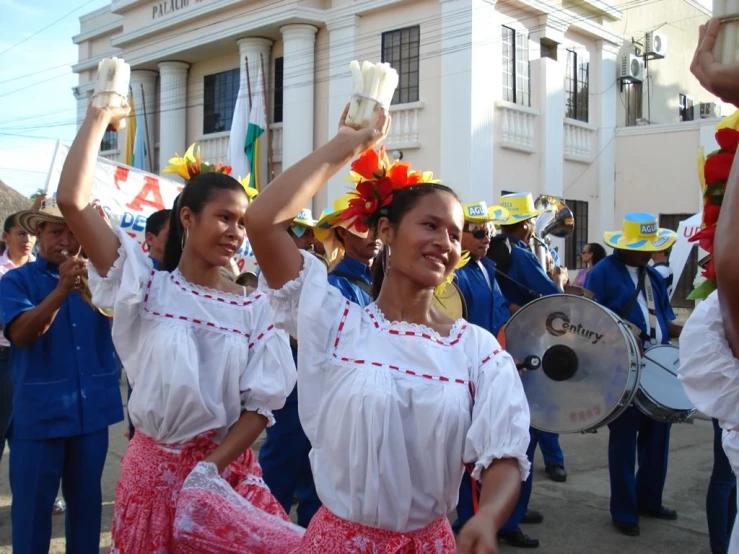 a couple of women dancing in front of some other people