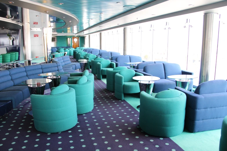 large long blue and green seating area with chairs