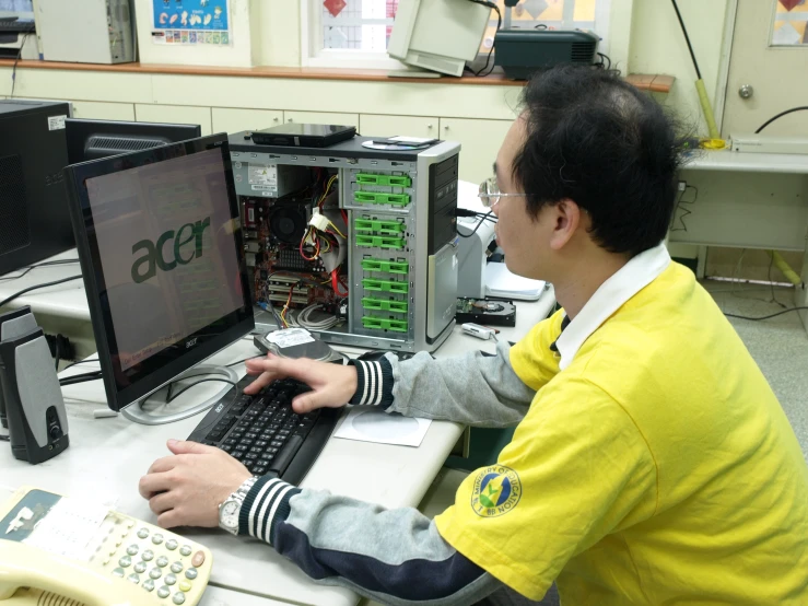 a person at a desk working on a computer