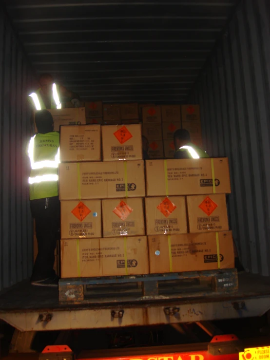 a worker in a cargo truck with several boxes