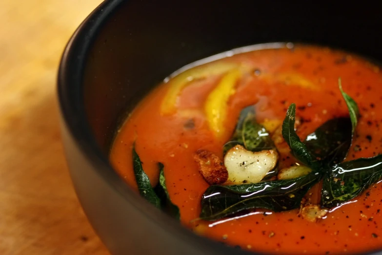 a close up of a bowl of soup on a table