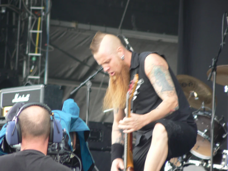 an image of a man playing the guitar on stage