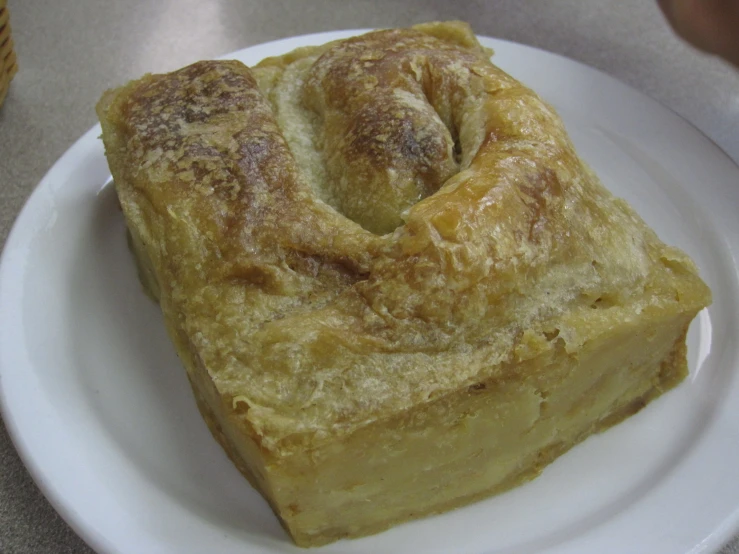 two pieces of a pastry sit on a white plate