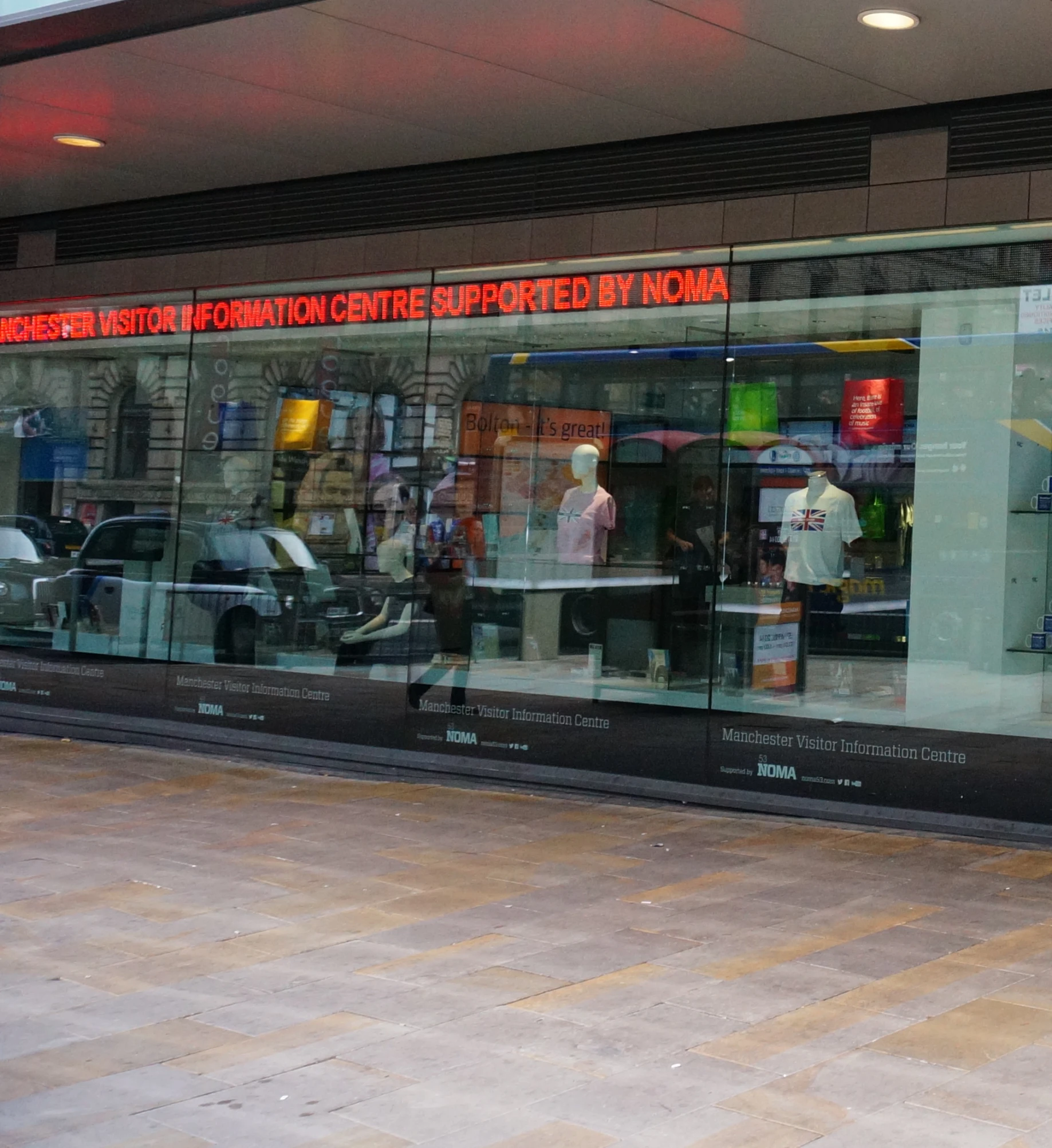 a man standing outside a store near a sidewalk