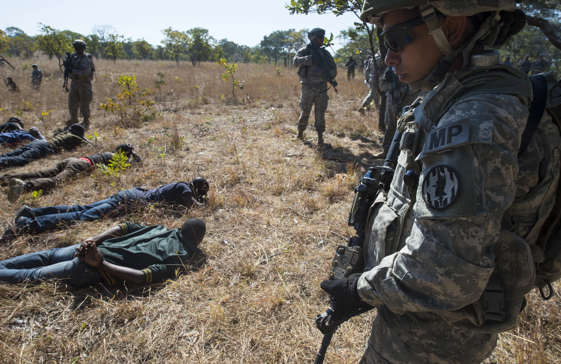 soldiers standing near injured bodies laying on the ground