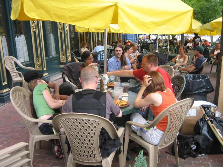 a group of people sitting at a table eating food