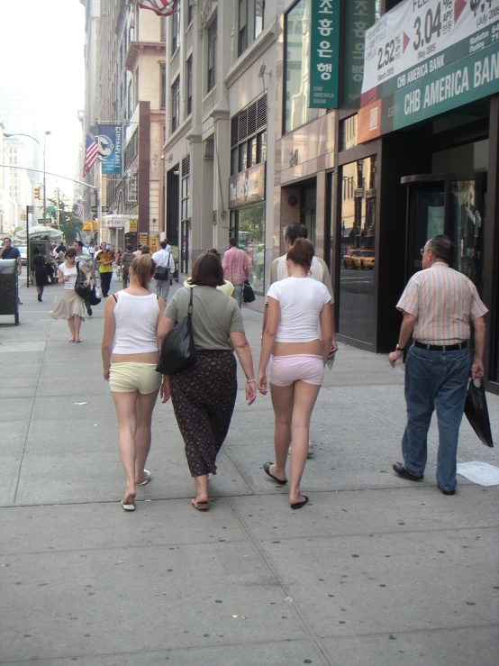 a group of people that are walking on a street