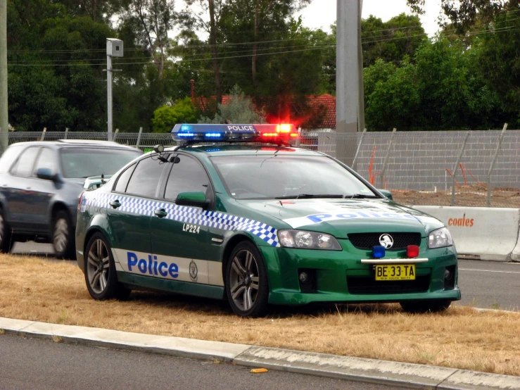 a police car parked next to two other cars