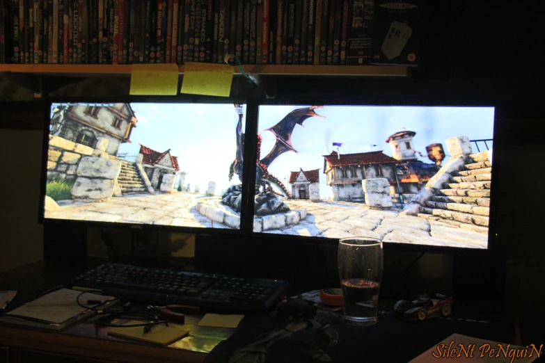 a computer screen is set up with game images on the monitor