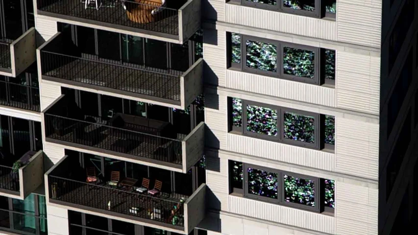 an aerial view of a very tall building with many balconies