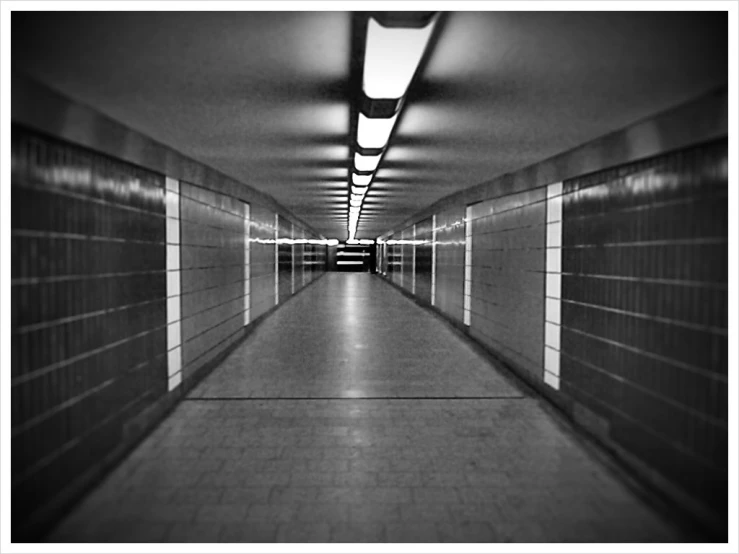 an empty hallway with some doors at the end