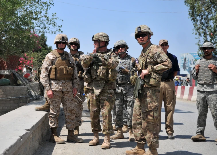 soldiers stand on the street while talking to each other