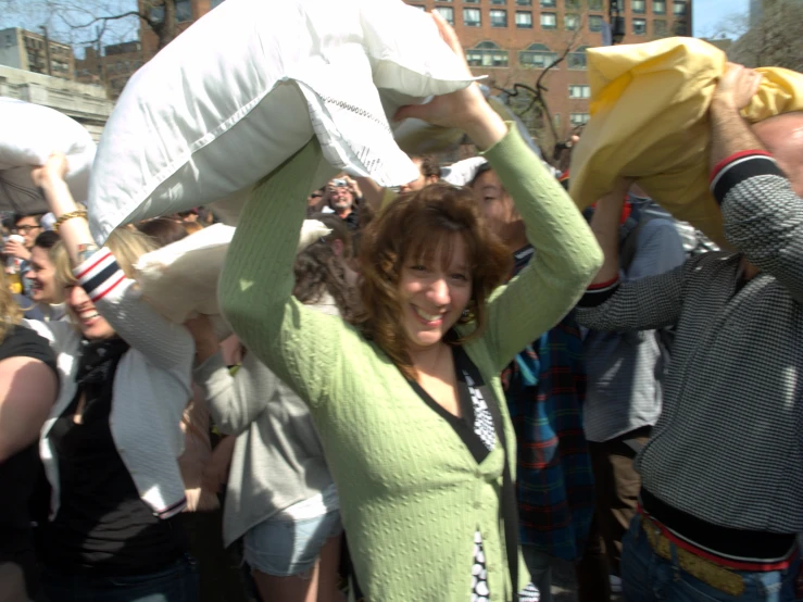 a woman carrying a huge bag and wearing head covering