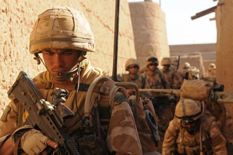 military soldiers wearing helmets and holding guns