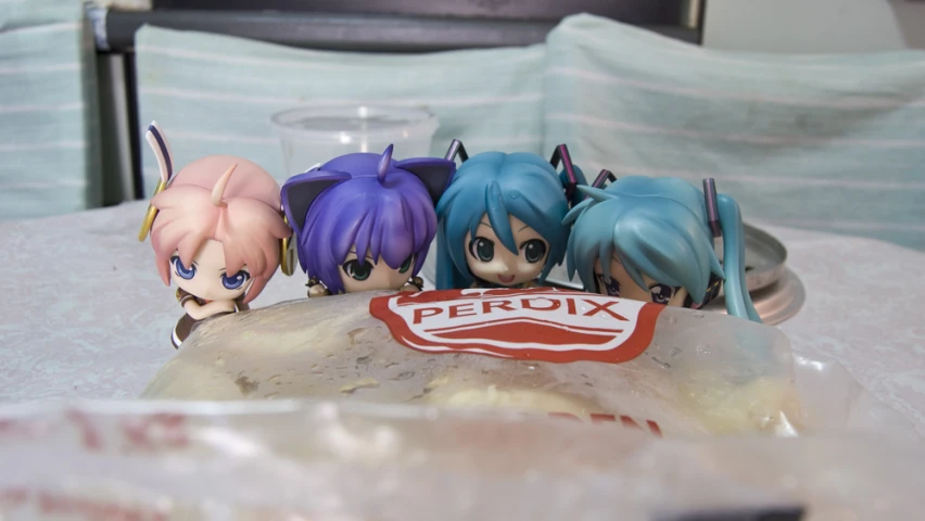 an assortment of anime figurines sitting on top of a plate