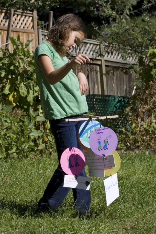 a little girl stands with her board outside