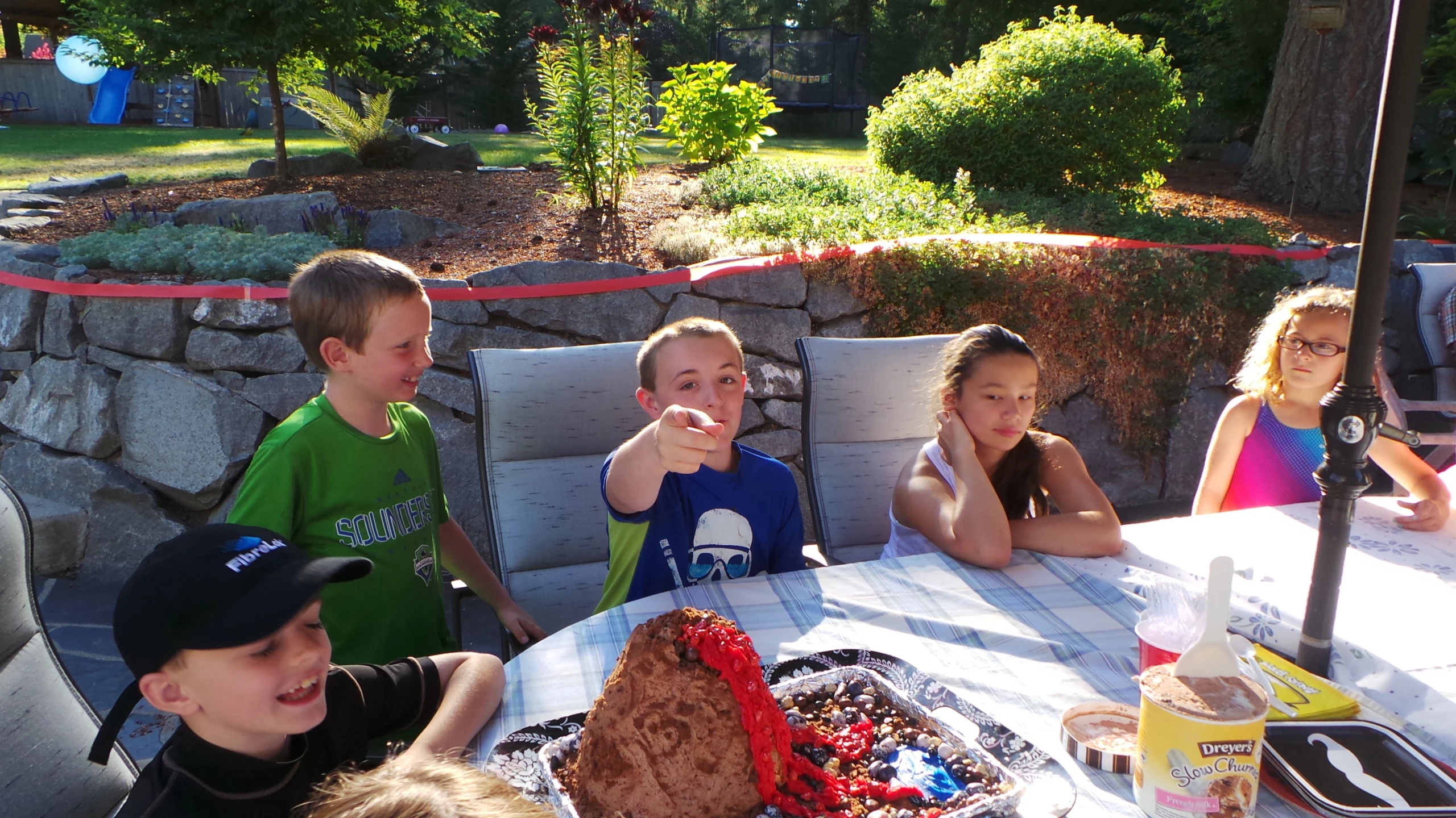 several s sitting around a table with cake on it