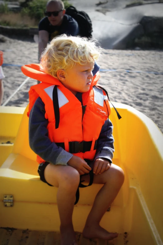 a  wearing a life jacket on a boat