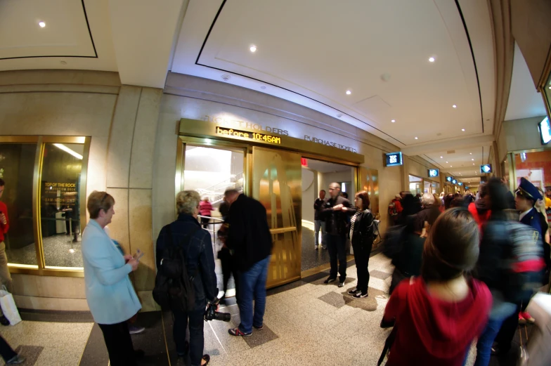 a crowd of people standing outside a building