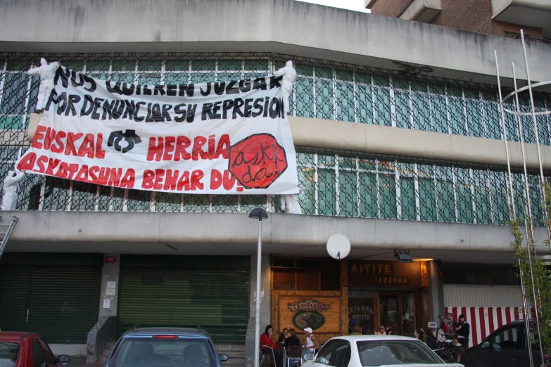 a large sign with foreign writing advertises herzbia for a woman's rights movement
