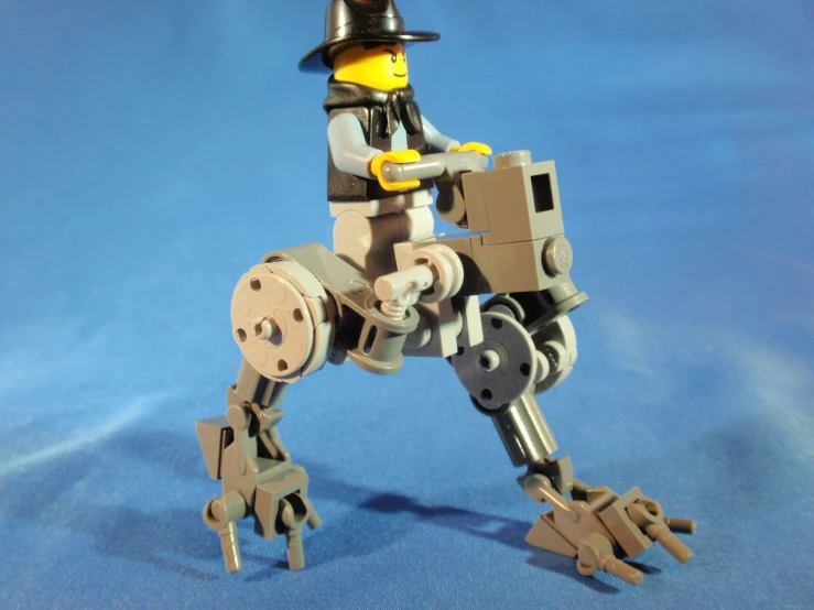 a lego figure is standing on an unicycle