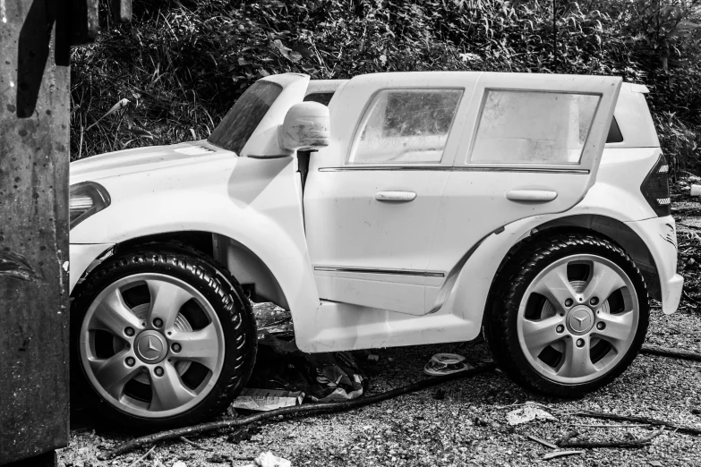 a car is parked on the roadside with its doors open