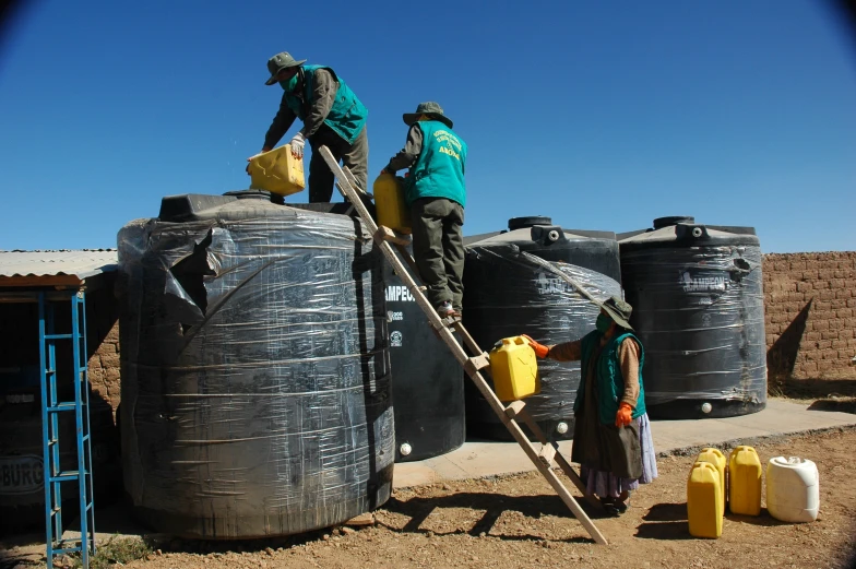 three people are working with water and water bags