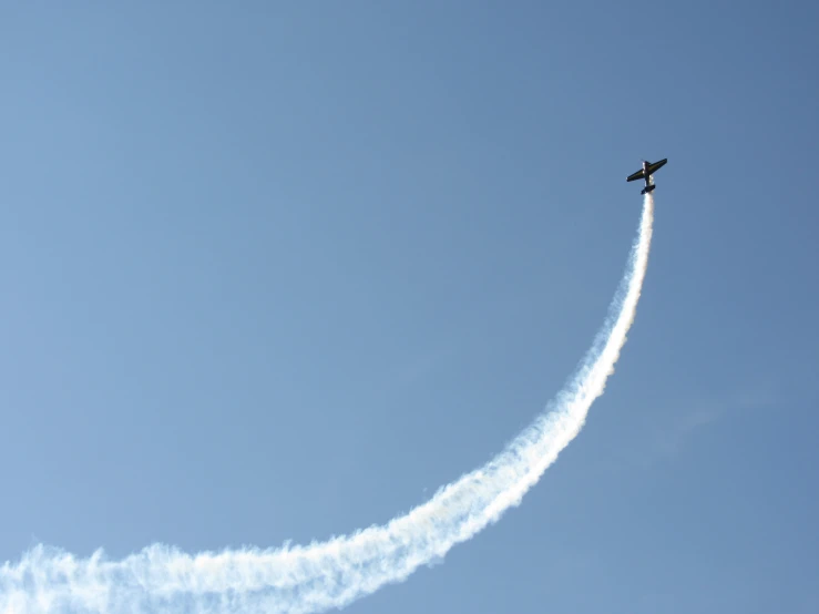 an airplane flying in the air making a contrail