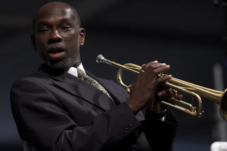 a man plays his trumpet at a concert