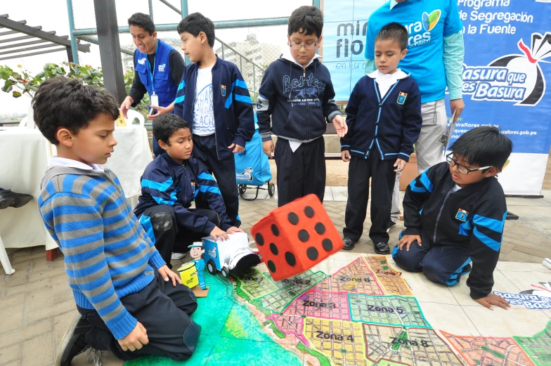 children playing with paper and colorful shapes