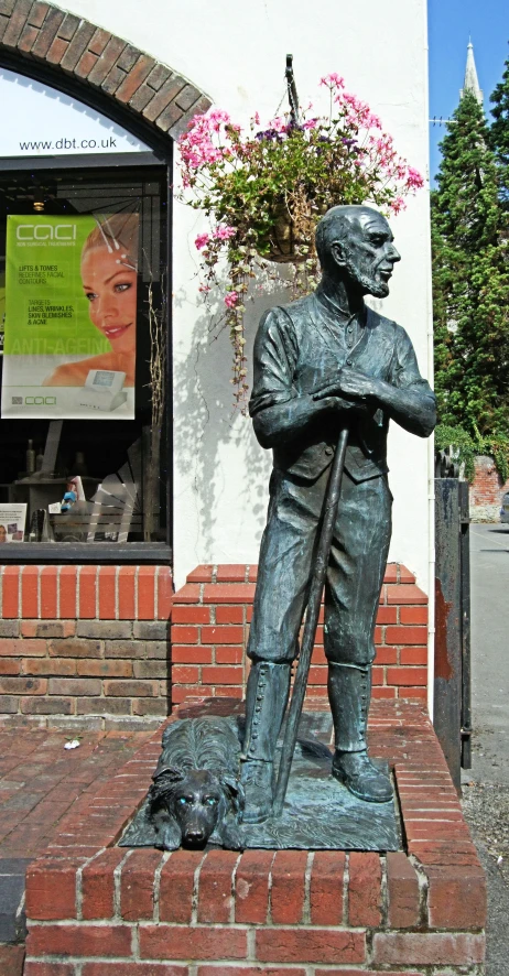 a statue of a man with a guitar, holding a cane, is outside