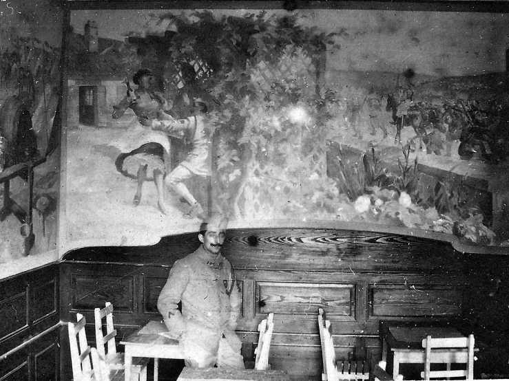 black and white pograph of teddy bear sitting in a chair with other teddy bears behind him