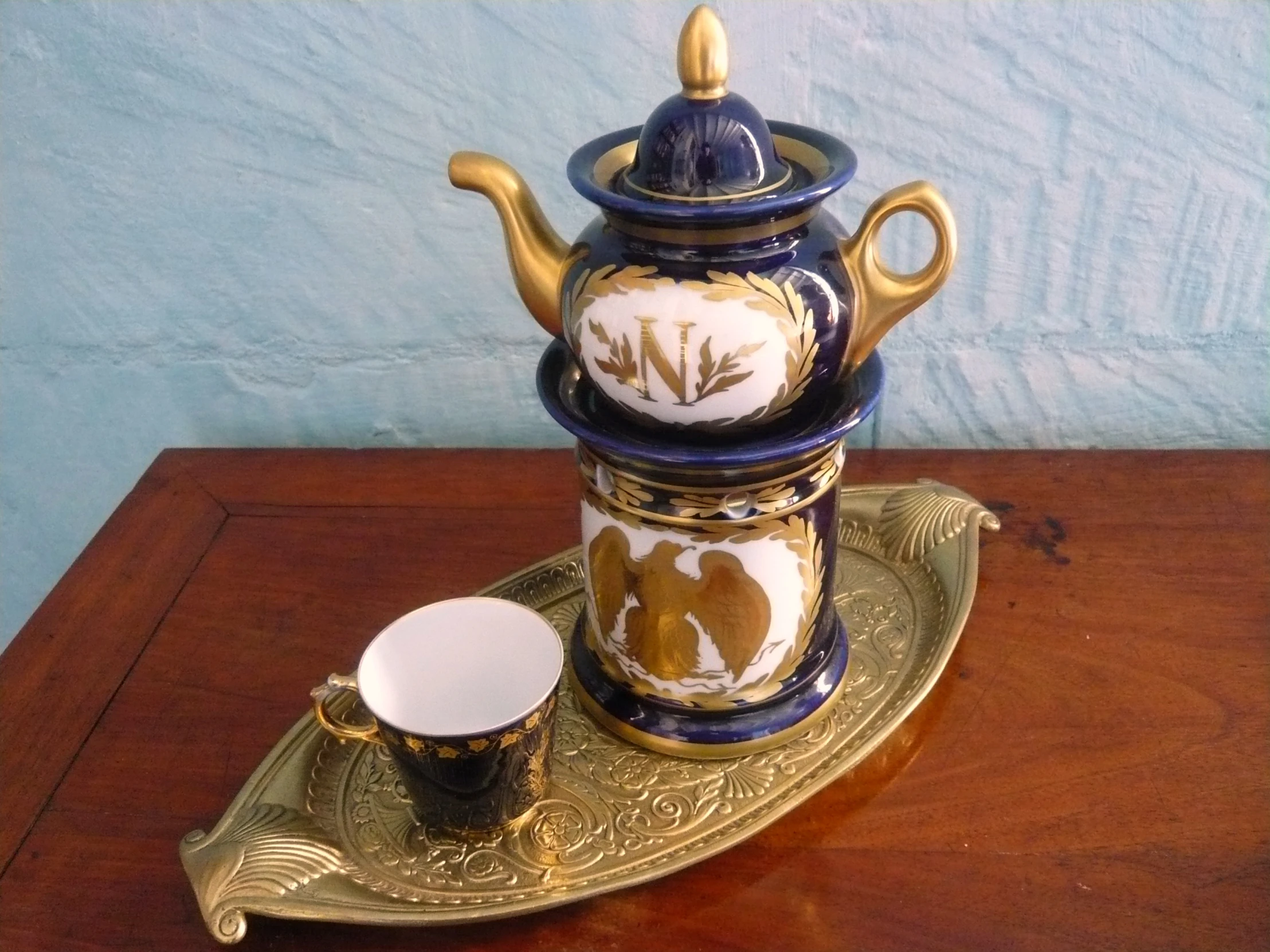 an ornate coffee set sitting on a tray