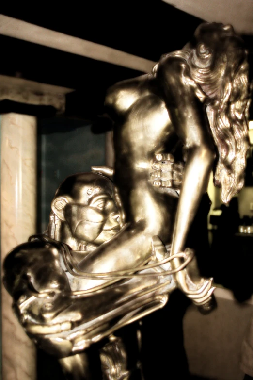 a statue that is holding an infant and sitting on its stomach