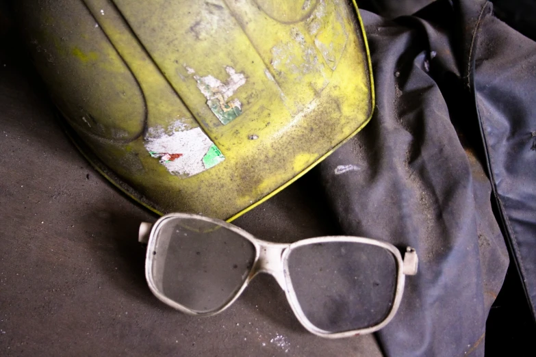 a pair of sunglasses next to a yellow suitcase