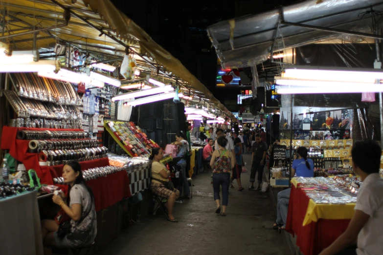 a crowded market that sells goods in it