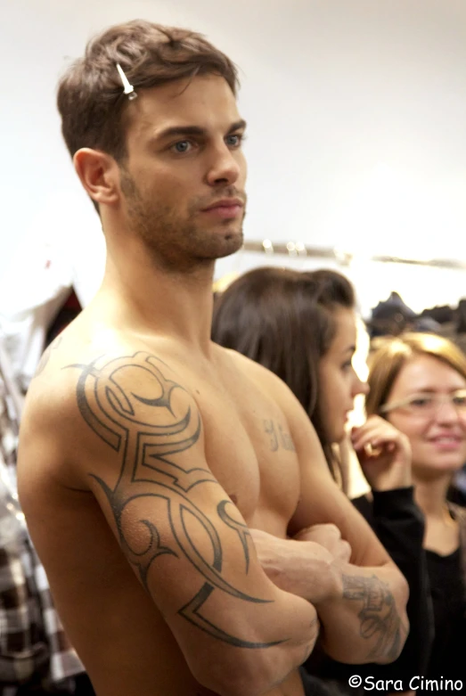 a man with a tribal tribal pattern on his arm and chest