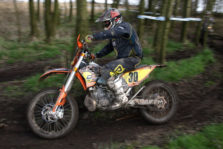 an athlete is riding his dirt bike in the mud