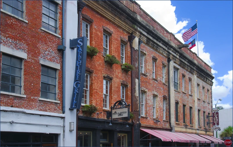 an old building has some flowers and american flag