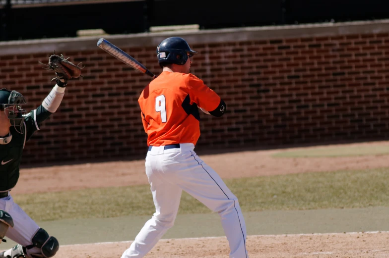 a baseball player in the process of swinging at a ball