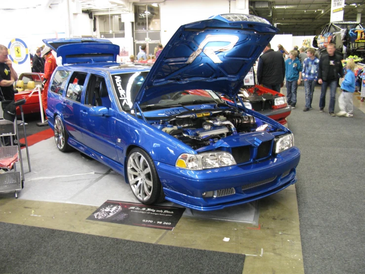 a blue subaru hatchback with the hood open