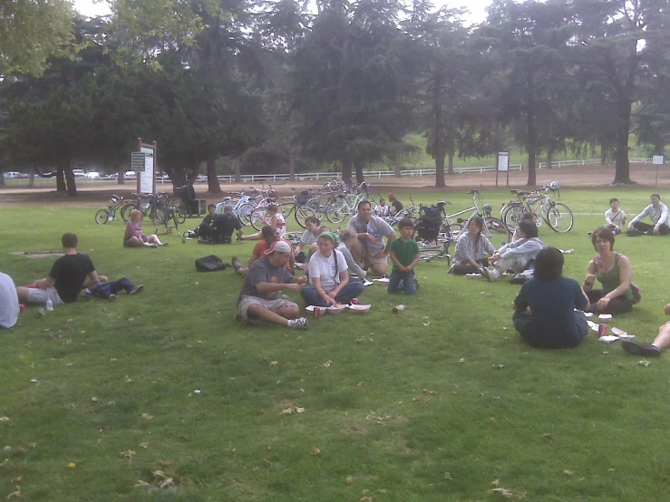 people sitting in the grass together and playing