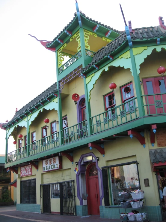 an old - fashioned chinese style building sits on the side of a road