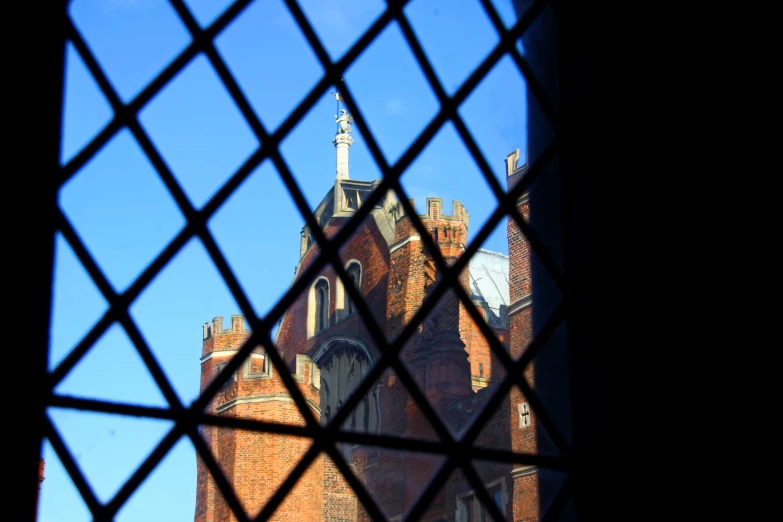 a very large building behind a chain link fence