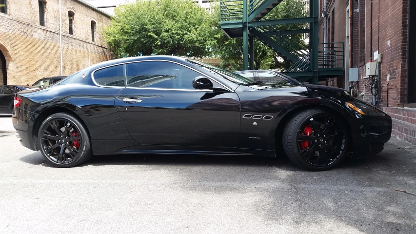 black sports car parked in a parking lot