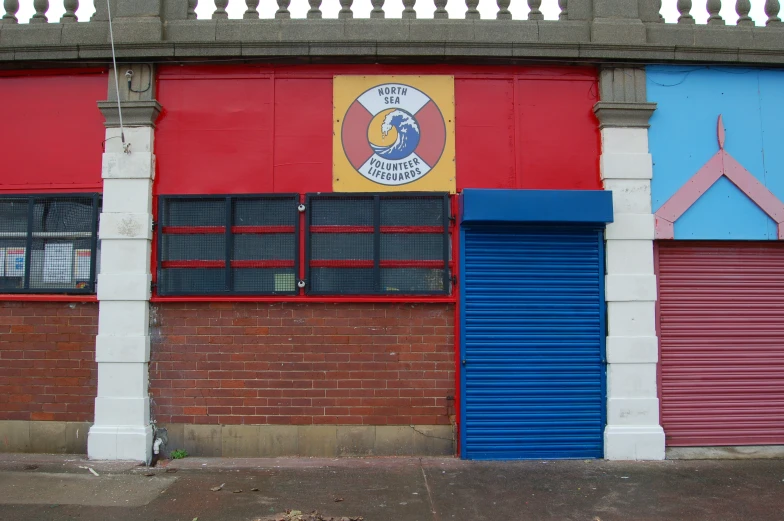 two colorful doors on the side of a building