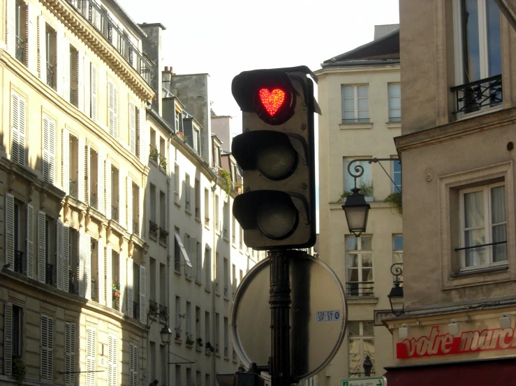 the red traffic light has a heart shaped heart on it