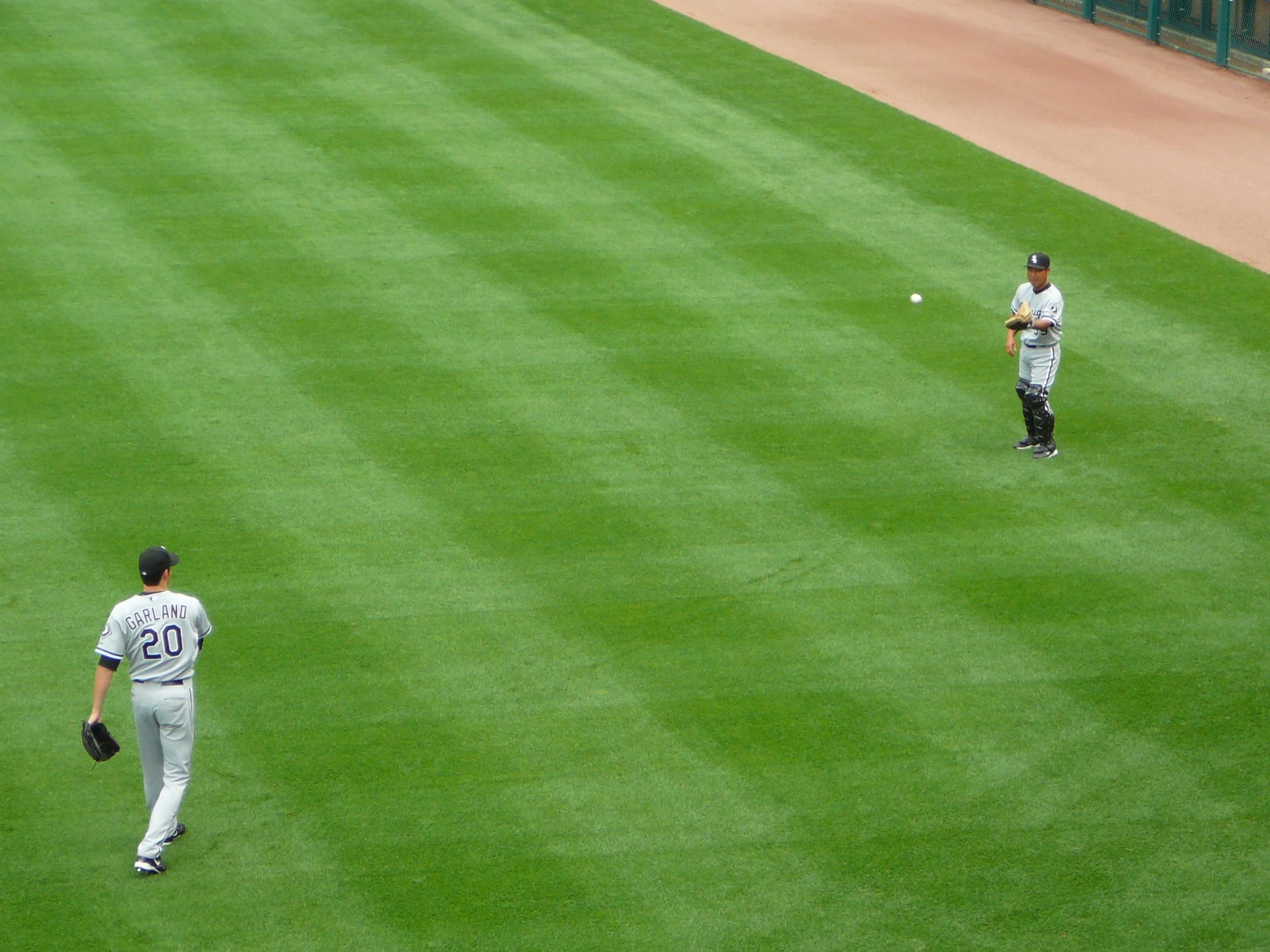 two people on a field playing baseball with each other